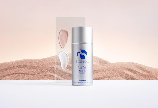 iS CLINICAL Eclipse SPF 50+ on a sandy background.