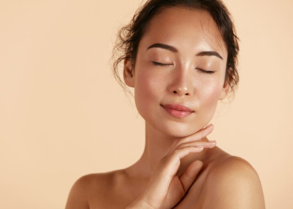 A woman with glowing skin after IPL treatment for rosacea and skin rejuvenation.