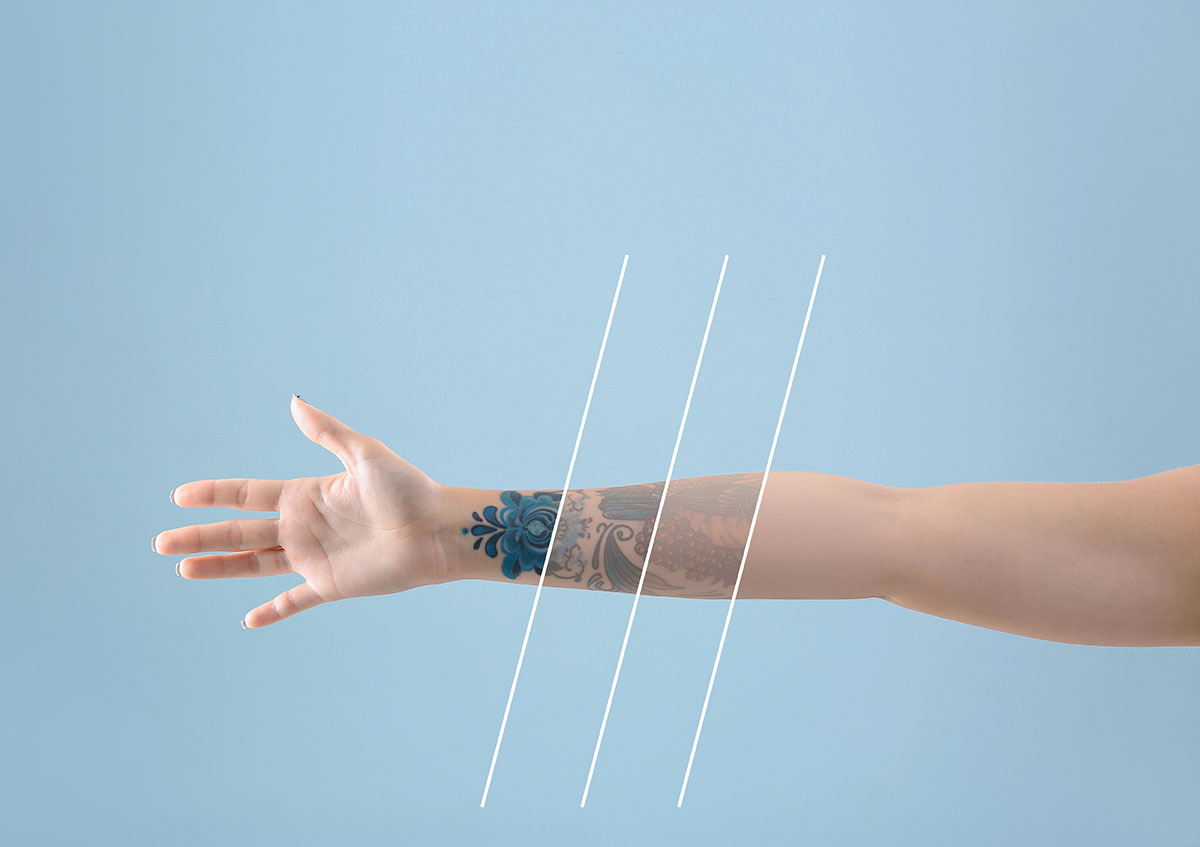 Outstretched arm with visible forearm tattoos and diagonal white lines over a blue background.